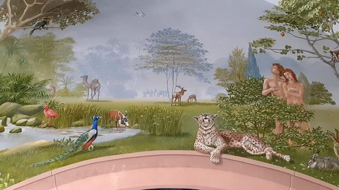 Darstellung vom Paradies,vor der Vertreibung. Adam und Eva und einige Tiere vor einer schönen Landschaft.